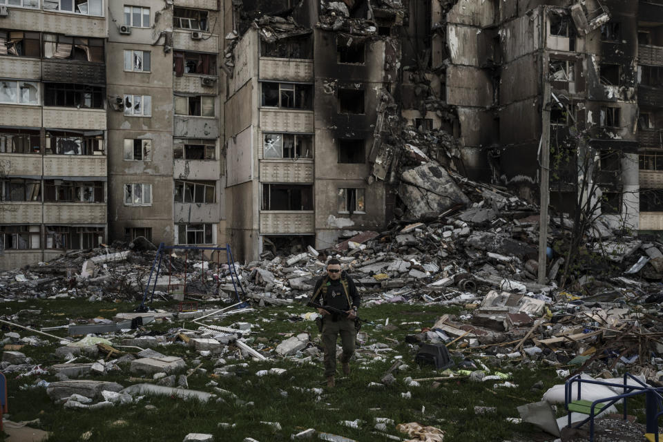 A Ukrainian serviceman walks amid the rubble of a building heavily damaged by multiple Russian bombardments in Kharkiv, Ukraine, A pril 25, 2022. / Credit: Felipe Dana/AP