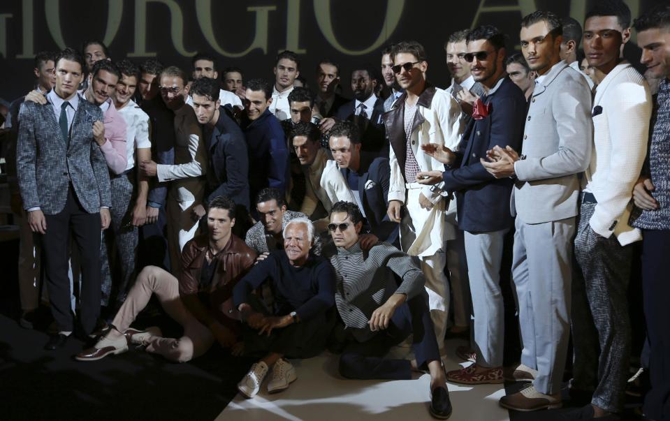 Italian fashion designer Giorgio Armani poses with models at the end of his men's Spring-Summer 2014 fashion show, part of the Milan Fashion Week, unveiled in Milan, Italy, Tuesday, June 25, 2013. (AP Photo/Luca Bruno)