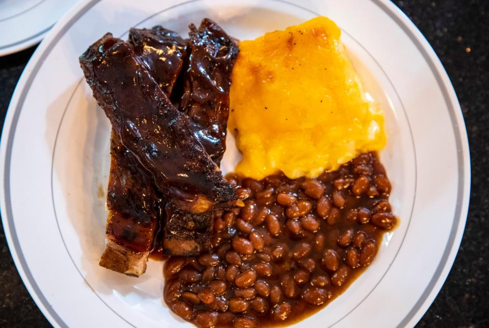 An order of ribs with beans and macaroni and cheese, prepared by Latrice Hudson, at Le Petit Dejeuner in Cathedral City.