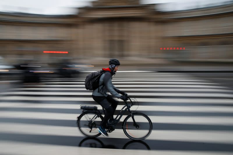 A person rides bicycle during rush hour as a strike by all unions of the Paris transport network (RATP) and French SNCF workers entered its seventh consecutive day in Paris