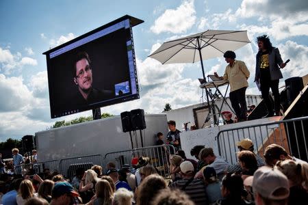 American whistleblower Edward Snowden is seen on a screen as he is interviewed by the performance group The Yes Men during the Roskilde Festival in Roskilde, Denmark, June 28 2016. Scanpix Denmark/Mathias Loevgreen Bojesen /via REUTERS