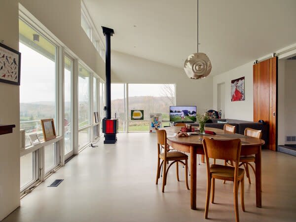 The dining area includes vintage Thonet chairs found at a local used furniture store and an orb pendant by Tom Dixon.