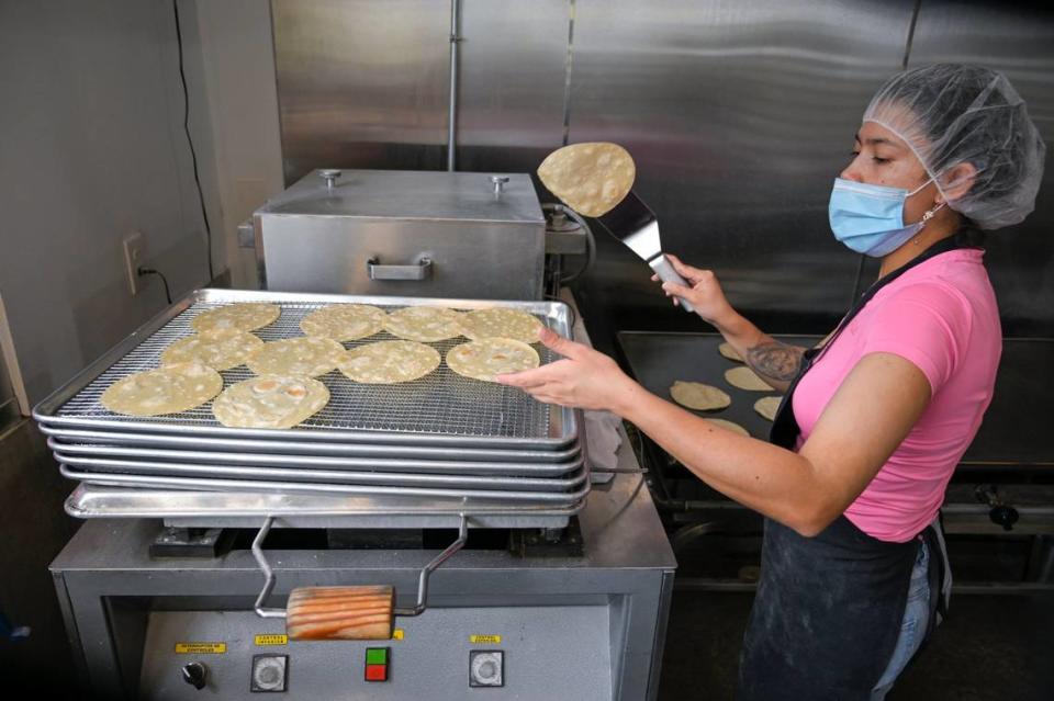 Diana Forero flips a tortilla onto a cooling rack before it’s packaged up and sent out to customers. Tammy Ljungblad/tljungblad@kcstar.com