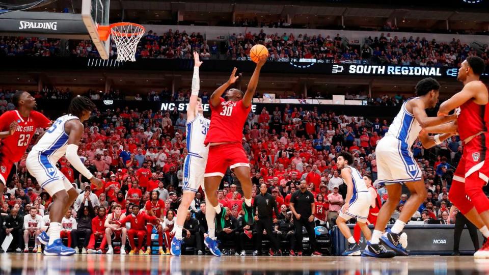 N.C. State’s DJ Burns Jr. (30) shoots as Duke’s Kyle Filipowski (30) defends during N.C. State’s 76-64 victory over Duke in their NCAA Tournament Elite Eight matchup at the American Airlines Center in Dallas, Texas, Sunday, March 31, 2024.