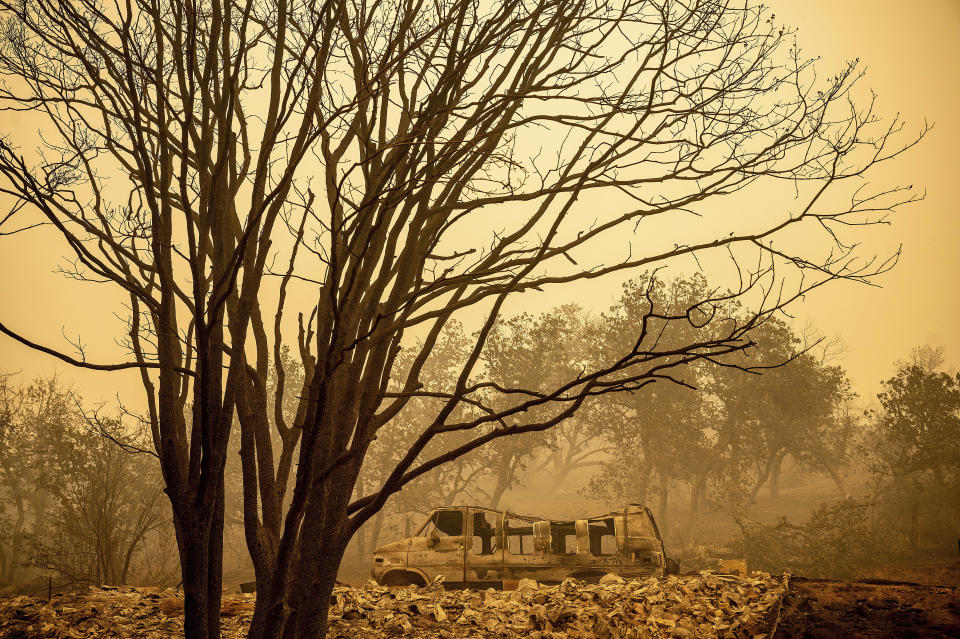 A scorched van sits in a clearing as the McKinney Fire burns in Klamath National Forest, Calif., on Sunday, July 31, 2022. (AP Photo/Noah Berger)