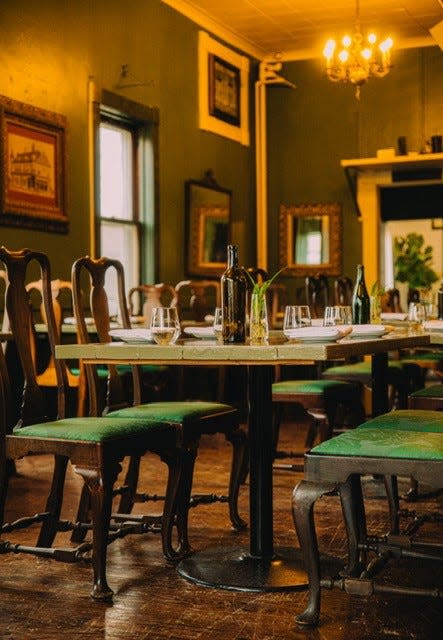 SAGE's dining room's transformation includes a wash of sage green paint, custom-built tables and a refinishing of the building's original bar top.