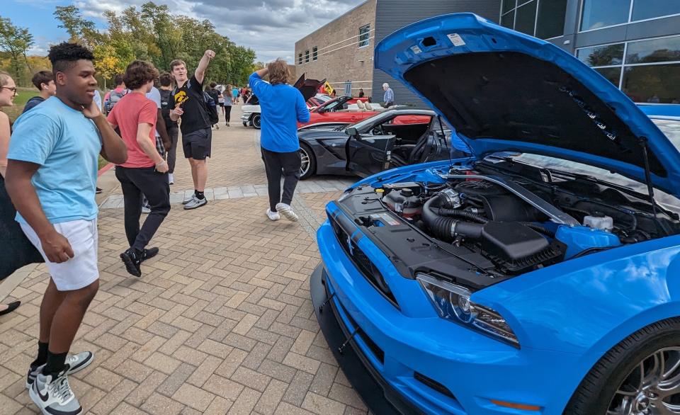 Liberty High sophomore Myles Cooper appears enthralled with the engine of this Ford Mustang displayed during last week’s classic car show at the school.