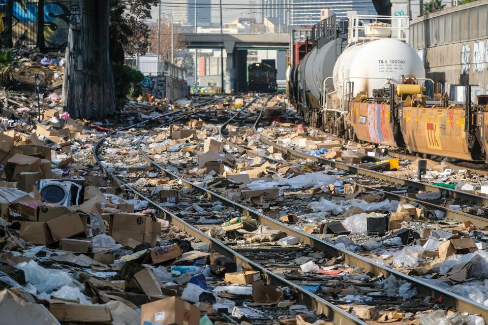 Shredded boxes and packages are seen at a section of the Union Pacific train tracks in downtown Los Angeles Friday, Jan. 14, 2022.  Thieves have been raiding cargo containers aboard trains nearing downtown Los Angeles for months, leaving the tracks blanketed with discarded packages. The sea of debris left behind included items that the thieves apparently didn't think were valuable enough to take, CBSLA reported Thursday. (AP Photo/Ringo H.W. Chiu)