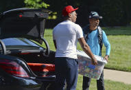 Carolina Panthers wide receiver DJ Moore gets an assist unloading a tub of candy and snacks from his trunk at the team's dormitory at NFL football training camp, Tuesday, July 27, 2021, at Wofford College in Spartanburg, S.C. (Jeff Siner/The Charlotte Observer via AP)