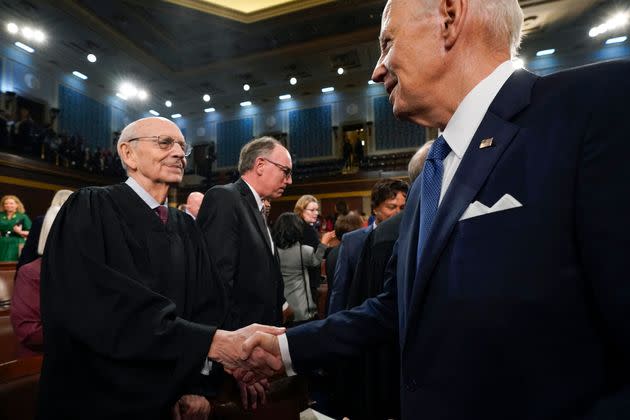 President Joe Biden shakes hands with retired Justice Stephen Breyer after the State of the Union address in the House Chamber of the Capitol in Washington, D.C., on Feb. 7, 2023.