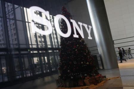 The logo of Sony Corp and a Christmas tree are reflected on the company's 4K television set at the company's headquarters in Tokyo November 18, 2014. REUTERS/Toru Hanai