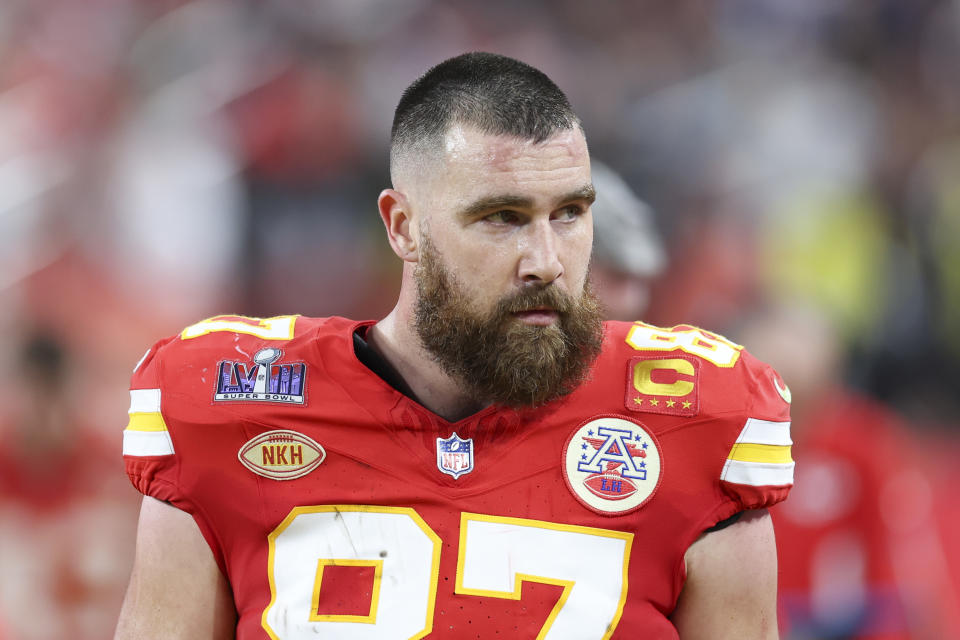 Person in a football uniform with the number 87 and a captain's patch, appearing focused