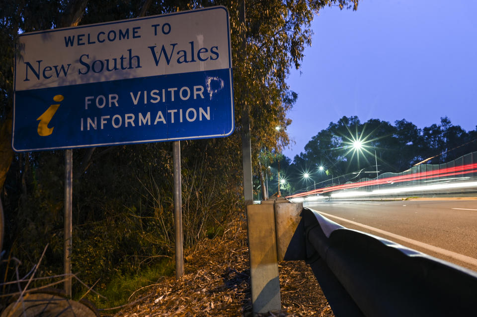 Cars cross the border from Victoria into New South Wales (NSW) in the NSW-Victoria border town of Albury, NSW.