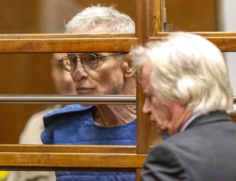 Edward Buck listens to his defense attorney Seymour Amster, right, during an appearance in Los Angeles Superior Court, Thursday, Sept. 19, 2019, in Los Angeles. The prominent LGBTQ political activist was arrested Tuesday and charged with operating a drug house and providing methamphetamine to a 37-year-old man who overdosed on Sept. 11, but survived, officials said. Two other men have died in his apartment since 2017. (AP Photo/Damian Dovarganes)