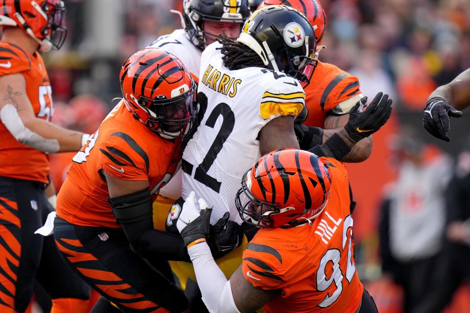 Cincinnati Bengals defensive end B.J. Hill (92) tackled Pittsburgh Steelers running back Najee Harris (22) in the third quarter during a Week 12 NFL football game, Sunday, Nov. 28, 2021, at Paul Brown Stadium in Cincinnati. The Cincinnati Bengals won, 41-10.