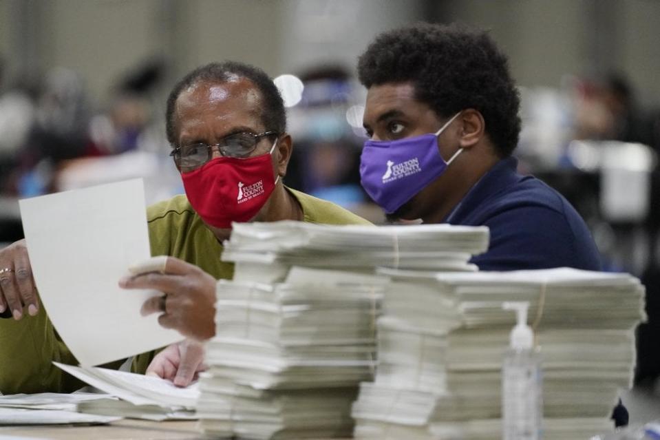 Officials sort ballots during an audit at the Georgia World Congress Center on Saturday, Nov. 14, 2020, in Atlanta. (AP Photo/Brynn Anderson)