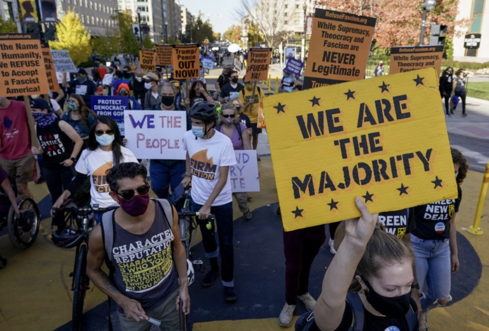 Demonstrators march through Black Lives Matter Plaza as they participate in a Count Every Vote rally on Friday in Washington. Source: AP