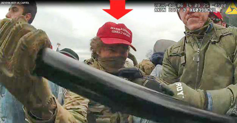 This image from U.S. Capitol Police video, released and annotated by the Justice Department in the statement of facts supporting an arrest warrant for Robert Morss, shows Morss, circled in red, appearing on police body-worn camera footage at the U.S. Capitol on Jan. 6, 2021, in Washington. Morss of Glenshaw, Pa., was sentencedto more than five years in prison after being convicted on three counts. Prosecutors say Morss, dressed in fatigues, and tried to trying to take a baton from an officer as well as shields and fencing and worked to organize members of the crowd to push past Capitol guards several times. (Justice Department via AP)