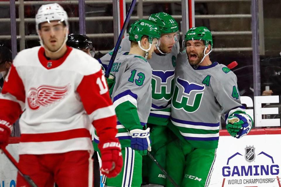 Carolina Hurricanes’ Jordan Staal (11), center, is congratulated on his goal by teammates Warren Foegele (13) and Jordan Martinook (48) during the first period of an NHL hockey game against the Detroit Red Wings in Raleigh, N.C., Saturday, April 10, 2021. (AP Photo/Karl B DeBlaker)