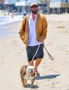 <p>Adam Sandler takes a walk with his dog on the beach on Sunday in Malibu. </p>