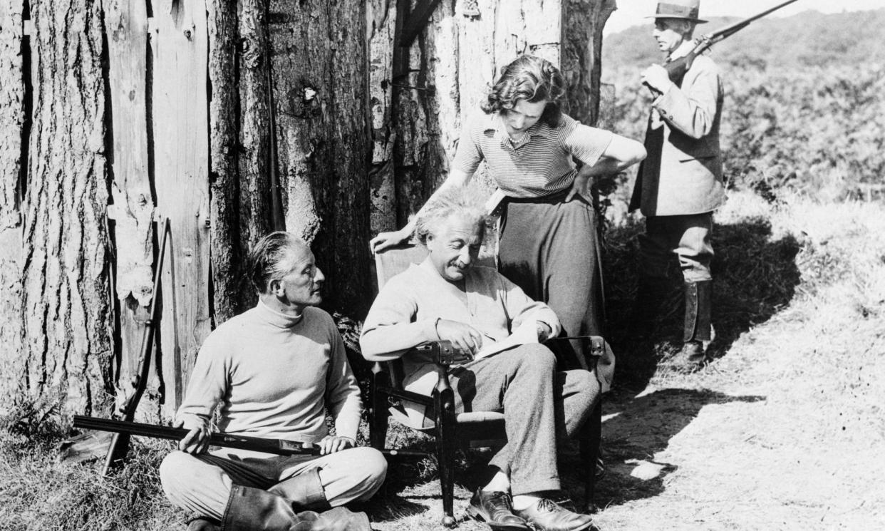 <span>Albert Einstein with his secretary B Howard, Oliver Locker-Lampson and an armed guard outside the hut in 1933.</span><span>Photograph: Bettmann/Bettmann Archive</span>