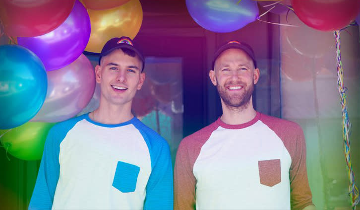 Nicholas Ruiz and Casey Fitzpatrick. smiling in front of colorful balloons. (via Troupe429)