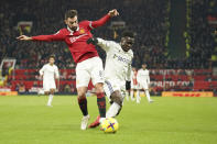 Manchester United's Bruno Fernandes, left vis for the ball with Leeds United's Wilfried Gnonto during the English Premier League soccer match between Manchester United and Leeds United at Old Trafford in Manchester, England, Wednesday, Feb. 8, 2023. (AP Photo/Dave Thompson)