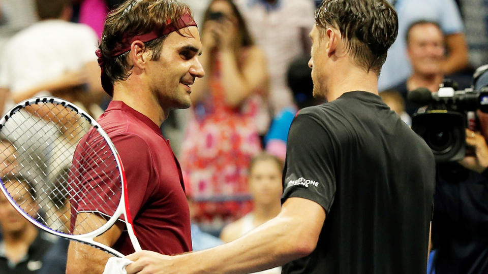 John Millman congratulates Roger Federer after defeating him. (Photo by Mohammed Elshamy/Anadolu Agency/Getty Images)