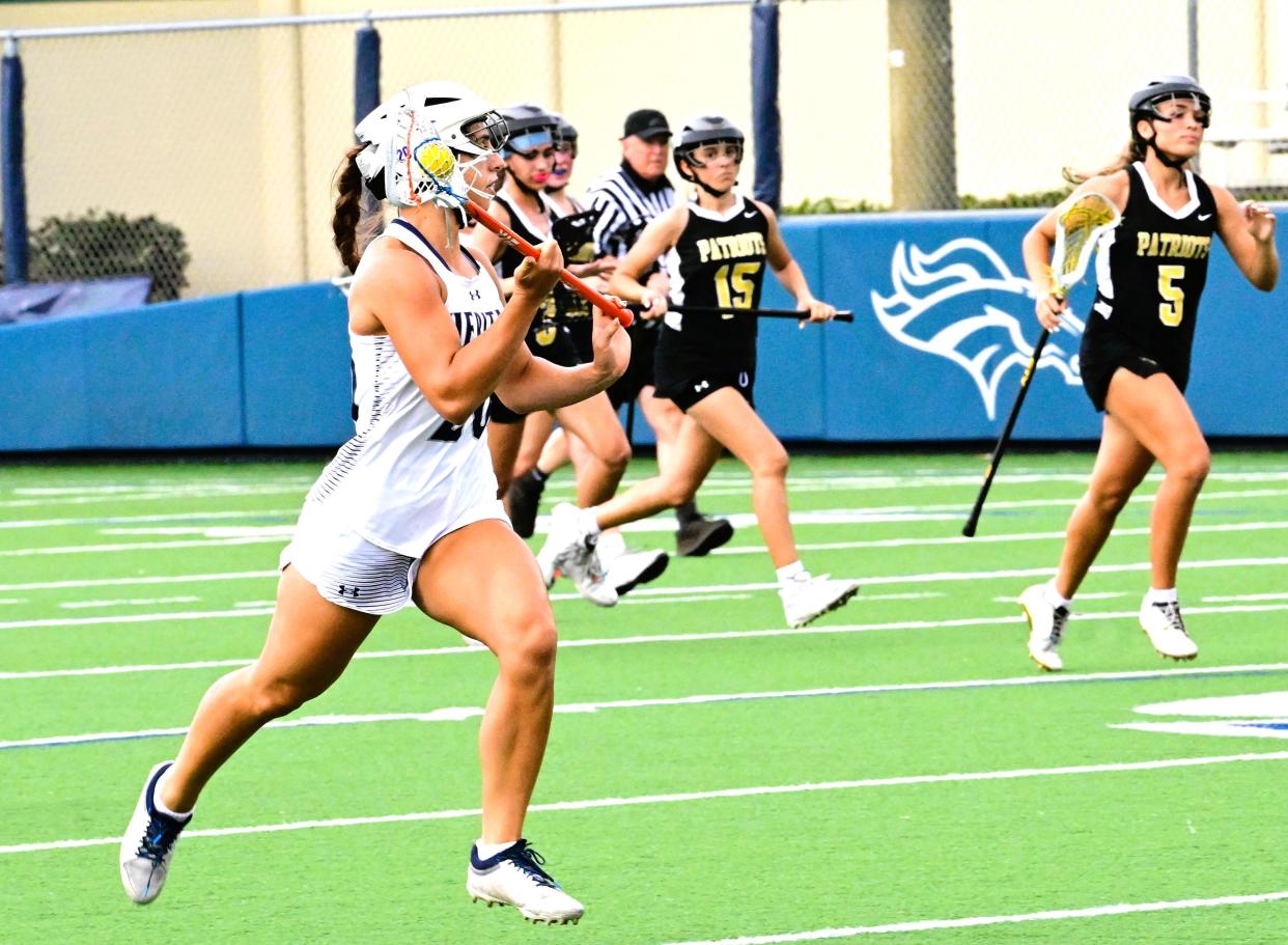 American Heritage-Delray's Chiara Scichilone brings the ball upfield during a regional semi-final win against American Heritage-Plantation on April 30, 2024.