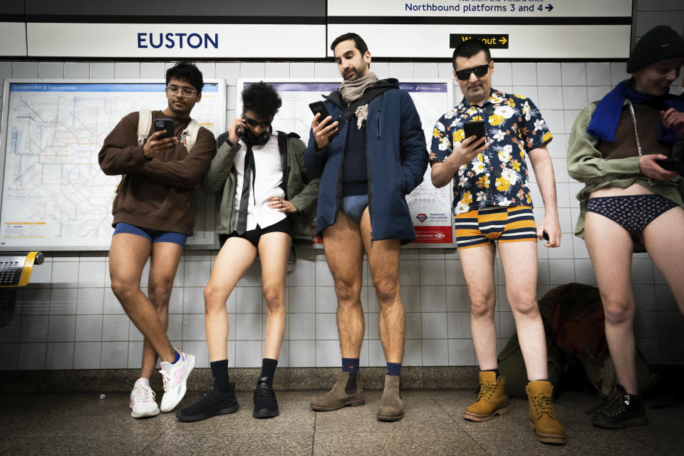People at Euston Station take part in the annual No Trousers Tube Ride, London, Sunday, Jan. 7, 2024. (James Manning/PA via AP)