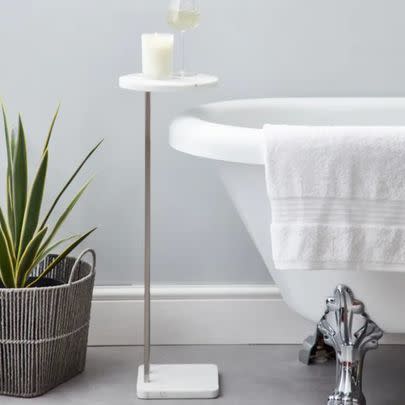 Display a candle or a plant on this pretty pedestal bath table