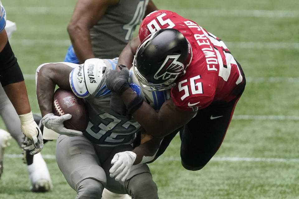 Atlanta Falcons defensive end Dante Fowler Jr. (56) stops Detroit Lions running back D'Andre Swift (32) during the second half of an NFL football game, Sunday, Oct. 25, 2020, in Atlanta. (AP Photo/John Bazemore)