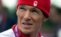 Canada's Simon Whitfield talks to reporters after crashing and retreating from the men's triathlon at Hyde Park during the Summer Olympics in London on Tuesday, August 7, 2012. THE CANADIAN PRESS/Sean Kilpatrick