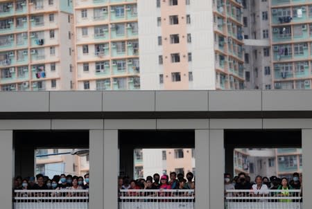 Anti-government protesters stand on a bridge as they gather in Tin Shui Wai in Hong Kong