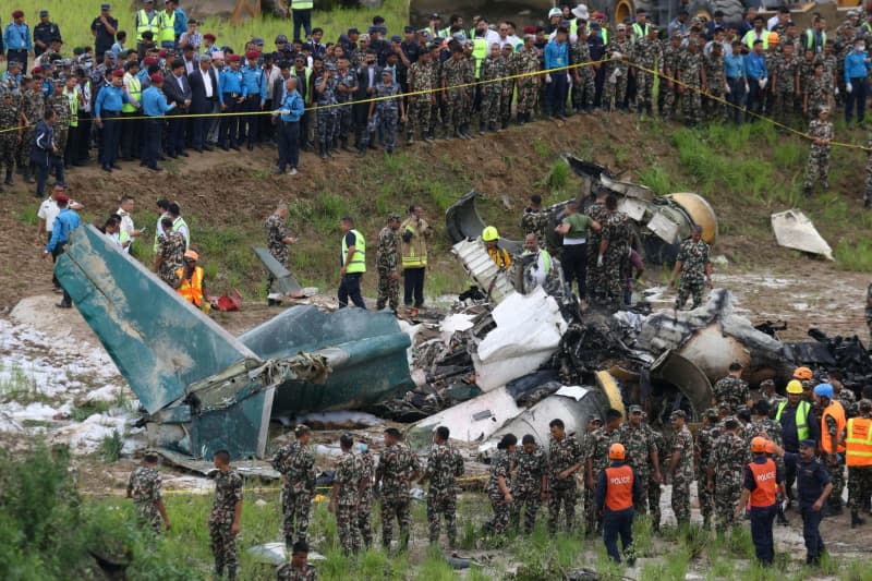 Rescuers work after a Saurya Airlines plane crashed at Kathmandu's Tribhuvan International Airport. At least 18 people have been confirmed dead after an airplane crashed in Nepal on Wednesday, police said. Aryan Dhimal/ZUMA Press Wire/dpa