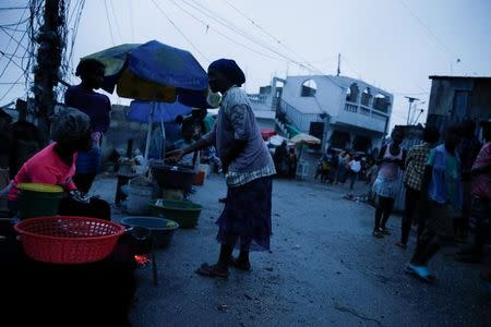 People buy goods on the street while Hurricane Matthew approaches Port-au-Prince, Haiti, October 3, 2016. REUTERS/Carlos Garcia Rawlins