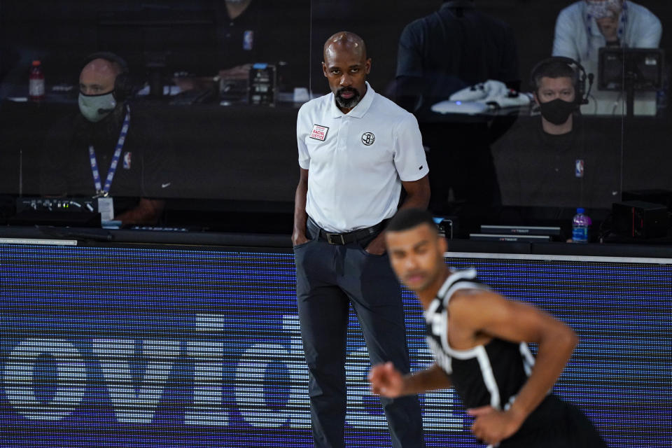 Brooklyn Nets head coach Jacque Vaughn watches from the sideline against the Milwaukee Bucks during the second half of an NBA basketball game Tuesday, Aug. 4, 2020 in Lake Buena Vista, Fla. (AP Photo/Ashely Landis)