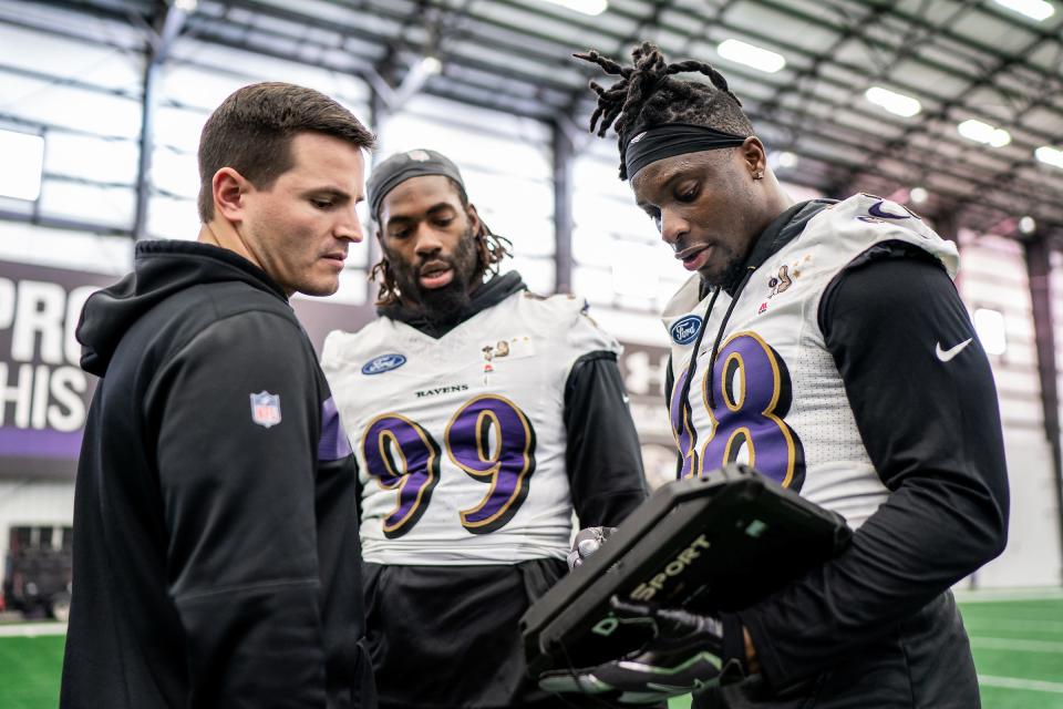 Baltimore Ravens linebackers coach Mike MacDonald with Patrick Onwuasor (48) and Matthew Judon (99) in 2019.