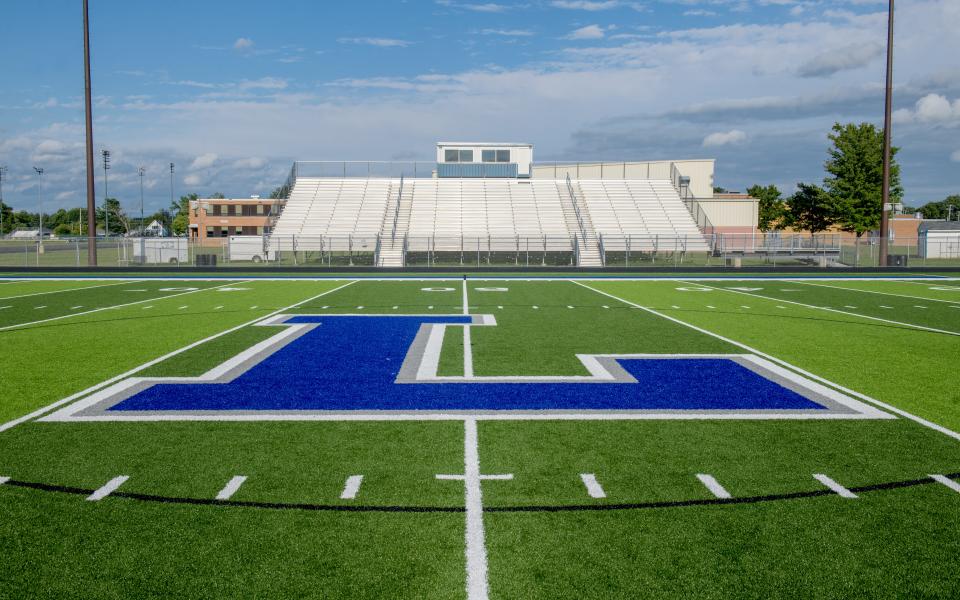 The bright blue "L" for Limestone adorns the 50-yard line of the new turf football field at Limestone High School's Frank Leach Stadium in Bartonville.