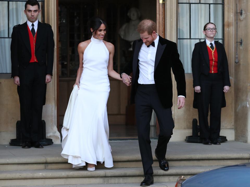 Duchess of Sussex and Prince Harry, Duke of Sussex leave Windsor Castle after their wedding to attend an evening reception at Frogmore House, hosted by the Prince of Wales on May 19, 2018 in Windsor, England
