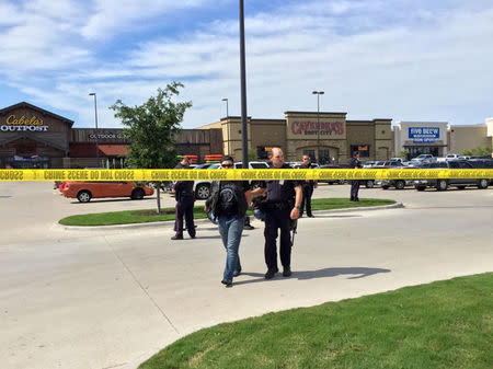 Police escort a man at the scene of a shooting in Waco, Texas, in this handout photo provided by the Waco Police Department on May 17, 2015. REUTERS/Waco Police Department/Handout