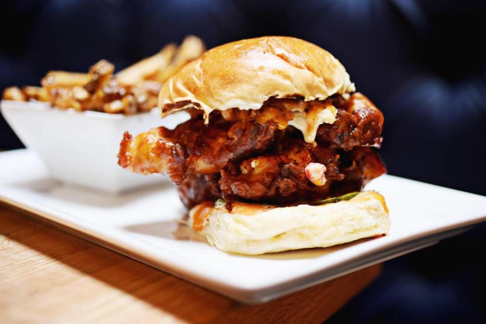Scratch Kitchen & Taproom’s chicken waffle sandwich is made up of sweet potato waffle-battered fried chicken with spicy maple syrup aioli, candied bacon and house pimento cheese with pickles and served on a brioche bun.