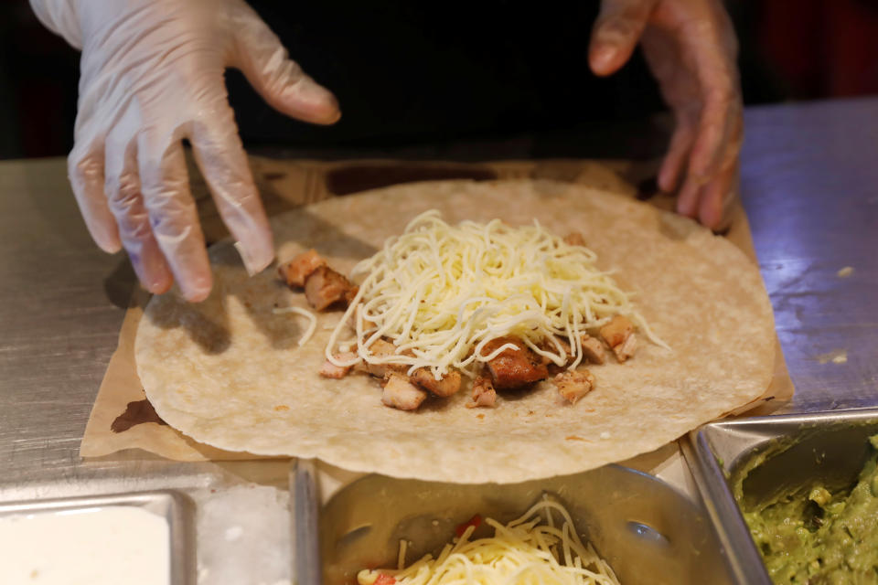 A Chipotle worker makes the new Quesadilla dish at the Chipotle Next Kitchen in Manhattan, New York, U.S., June 28, 2018.  REUTERS/Shannon Stapleton