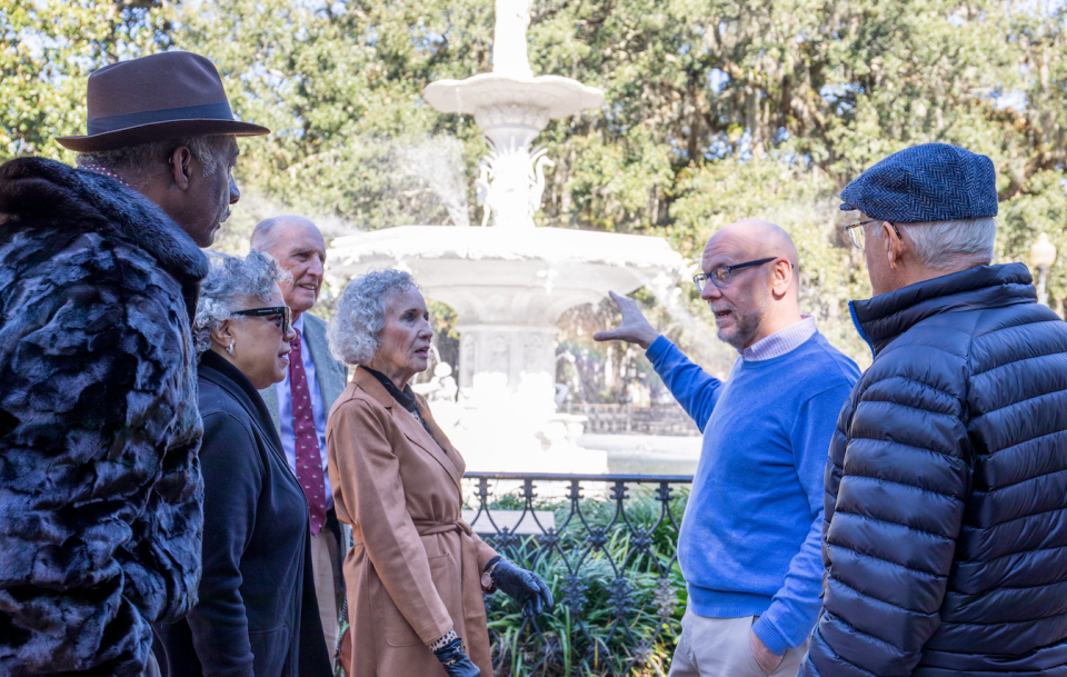 The Learning Center founder Roger Smith (blue sweater) leads a history tour at Forsyth Park.