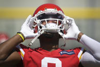 Kansas City Chiefs wide receiver JuJu Smith-Schuster puts his helmet on during the NFL football team's mandatory minicamp Tuesday, June 14, 2022, in Kansas City, Mo. (AP Photo/Reed Hoffmann)