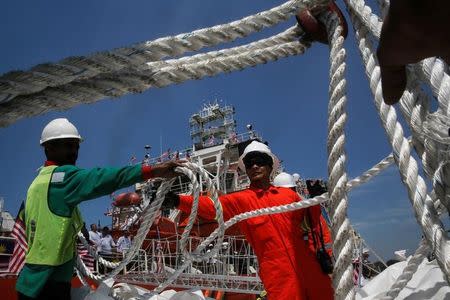 Crew members load supplies on a Malaysian ship, carrying aid for Rohingya, to set sail for Myanmar in Port Klang, Malaysia February 3, 2017. REUTERS/Joshua Paul