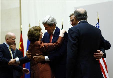 U.S. Secretary of State John Kerry (3rd R) hugs European Union foreign policy chief Catherine Ashton after she delivered a statement during a ceremony next to British Foreign Secretary William Hague (L), Germany's Foreign Minister Guido Westerwelle (R) and French Foreign Affairs Minister Laurent Fabius at the United Nations in Geneva November 24, 2013. REUTERS/Denis Balibouse
