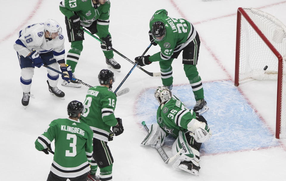 Tampa Bay Lightning left wing Ondrej Palat, top left, scores on Dallas Stars goaltender Anton Khudobin (35) during the second period of Game 3 of the NHL hockey Stanley Cup Final, Wednesday, Sept. 23, 2020, in Edmonton, Alberta. (Jason Franson/The Canadian Press via AP)