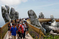 Tourists walk along Gold Bridge on Ba Na hill near Danang city, Vietnam August 1, 2018. REUTERS/Kham