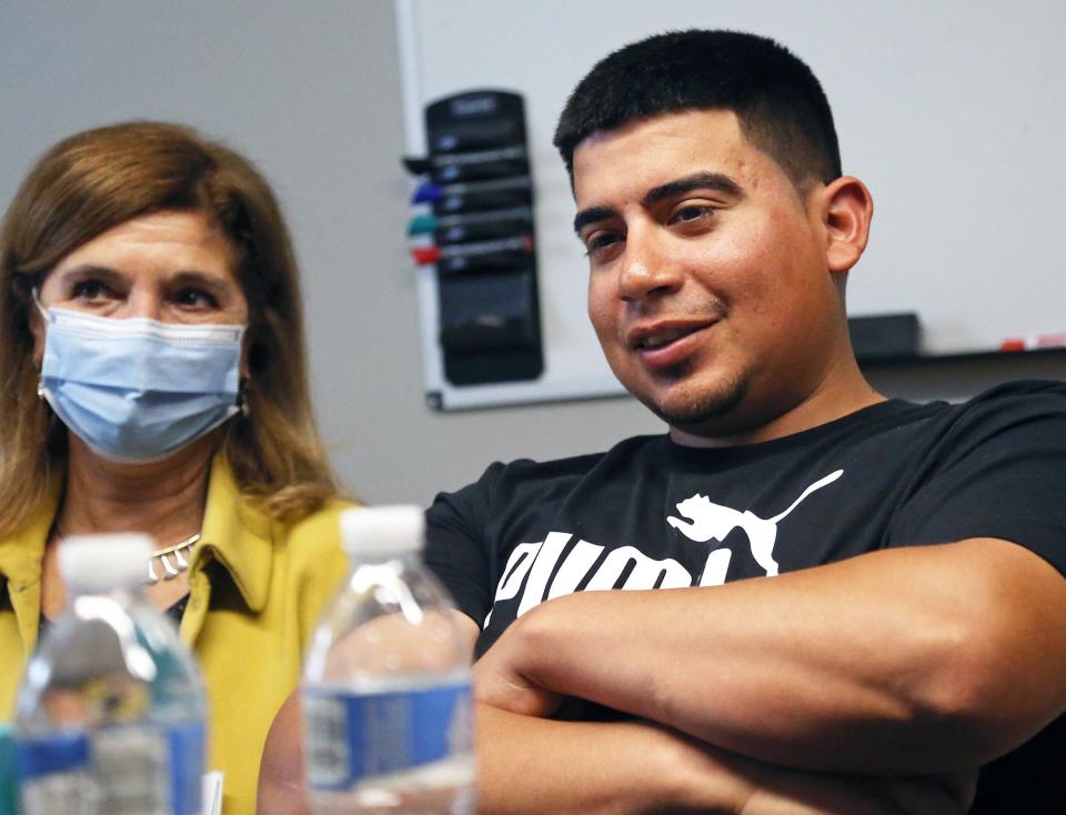 Interpreter Angela Hoke, left, translates for José Daniel Guerra-Castañeda during an interview at ACLU-NH's office in Concord, New Hampshire, on May 11, 2022.